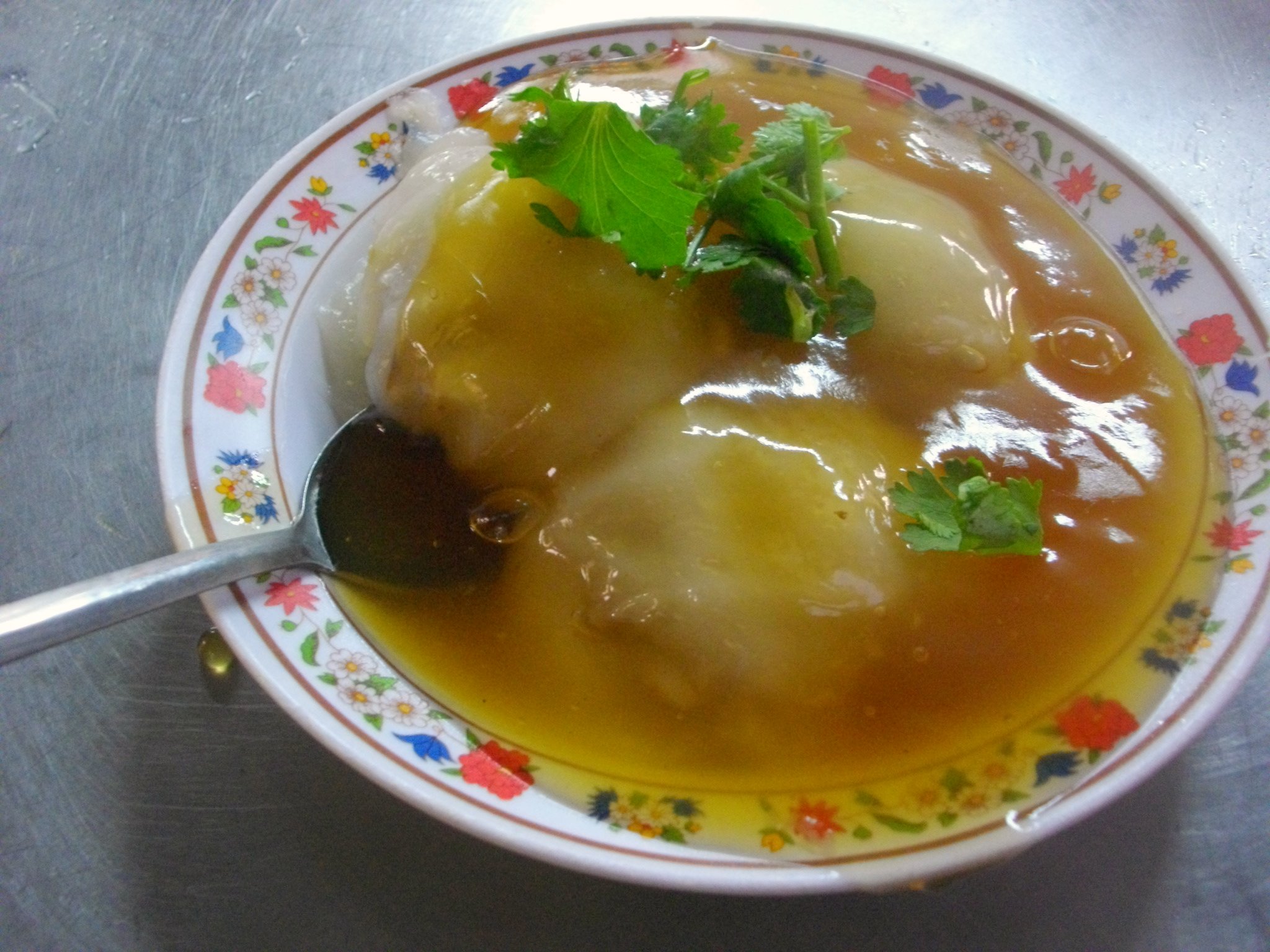 bowl of soup that includes green vegetables and soup