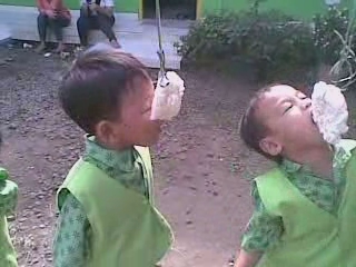 two children are putting soing in their mouth