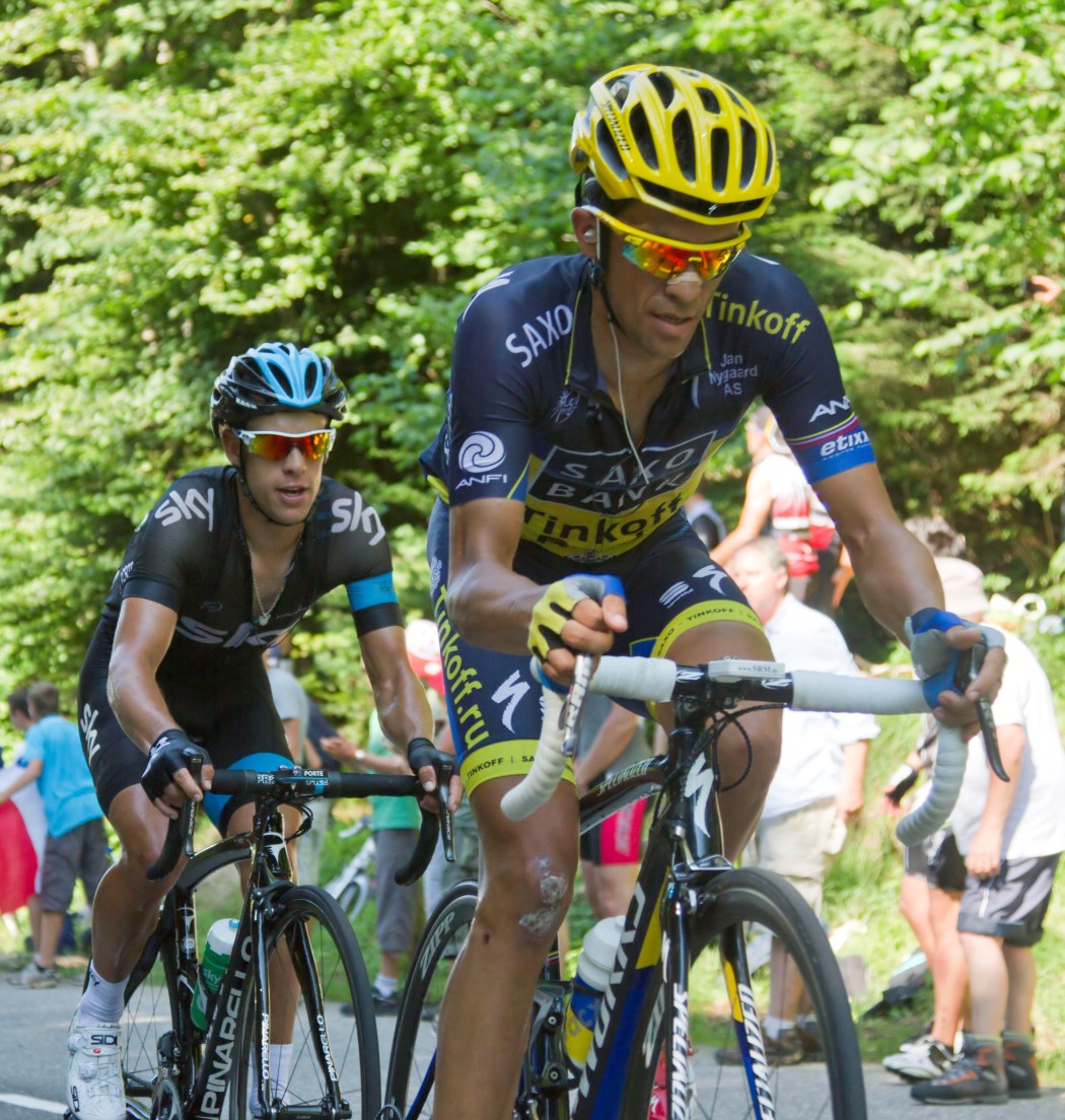 a man riding a bike down the side of a road