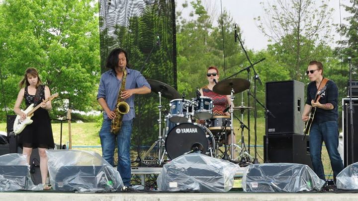 a group of people on stage playing with musical instruments