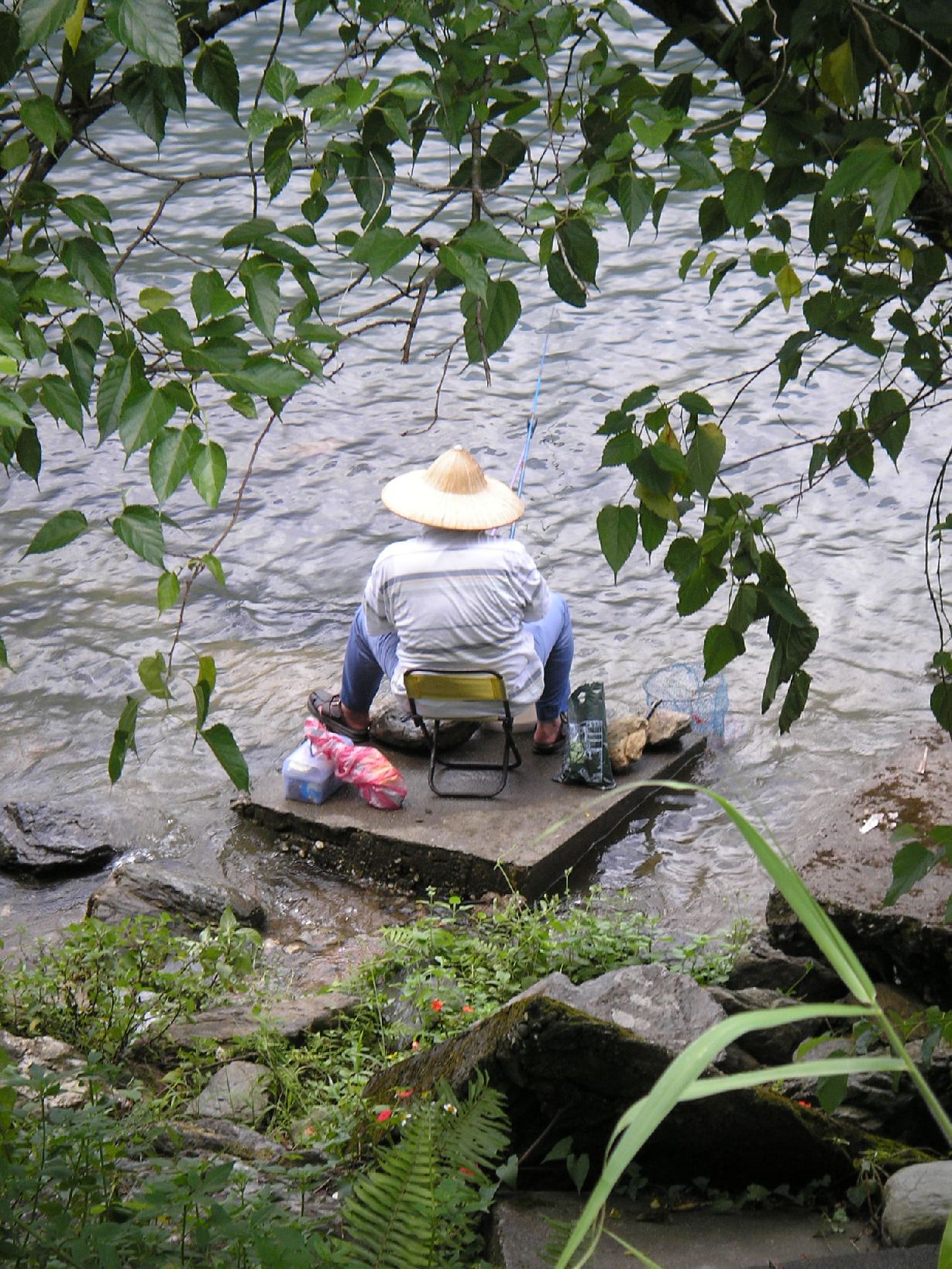 a man sitting on a chair in the water