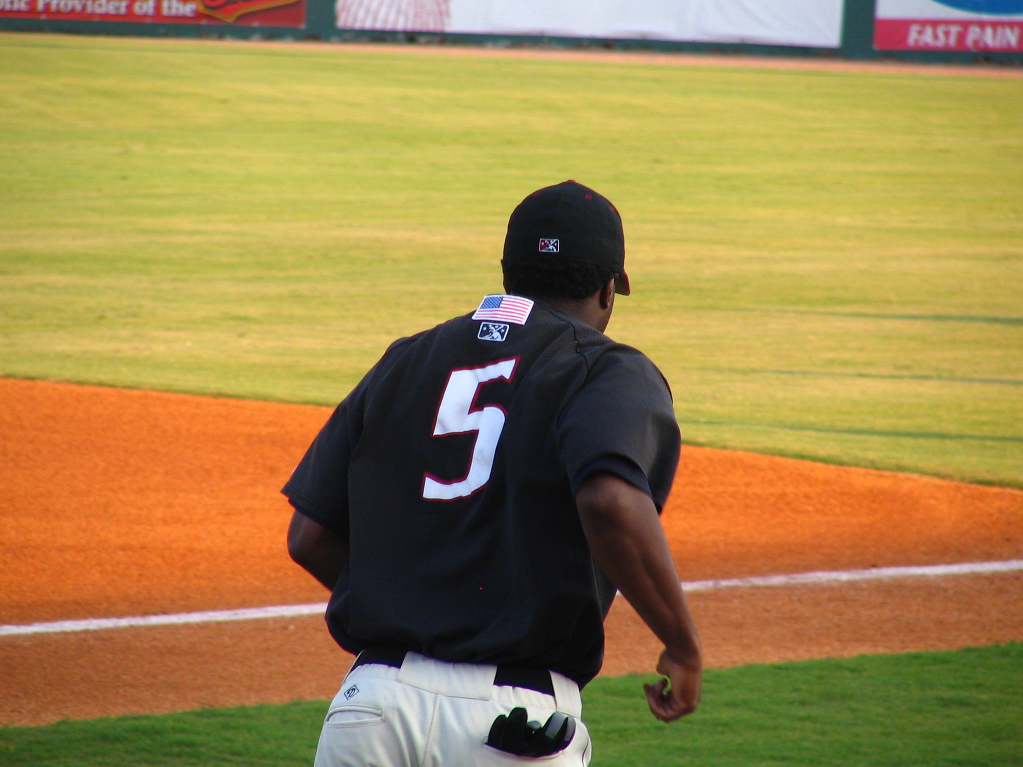 a baseball player stands on the field