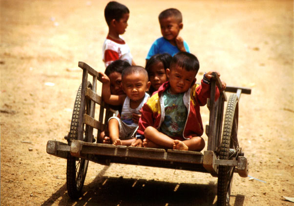 children are in the small wagon they are holding