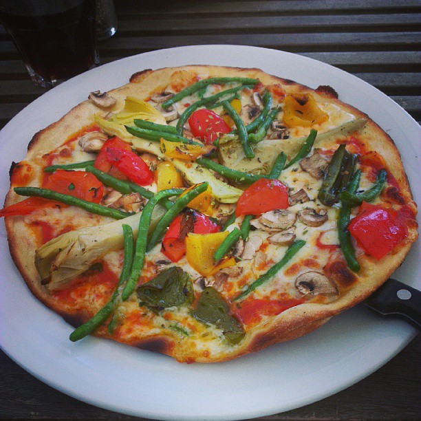 a pizza sitting on top of a white plate