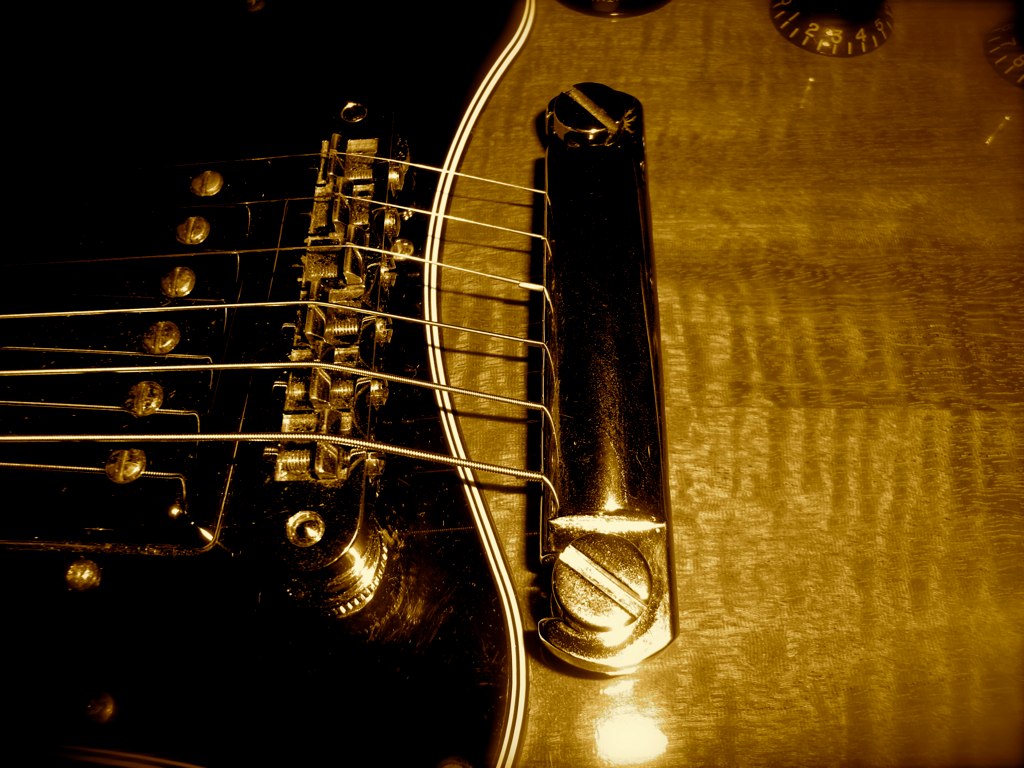 an electric guitar sitting on top of a wooden floor