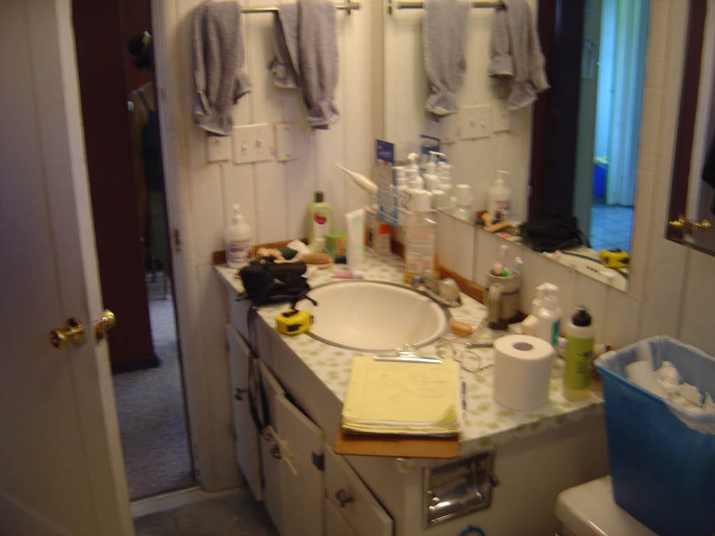 a bathroom with a sink and many small objects