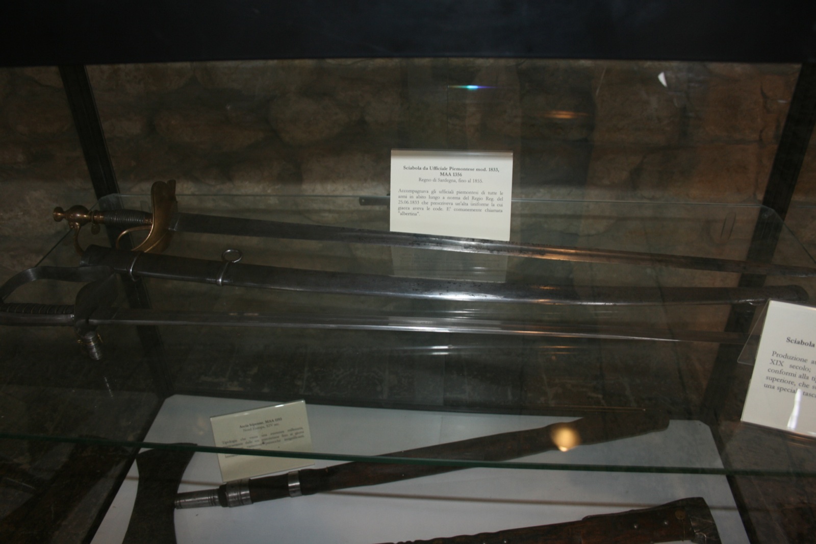 some sword shaped object in a glass case