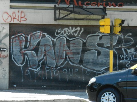 a car is driving past graffiti covered buildings