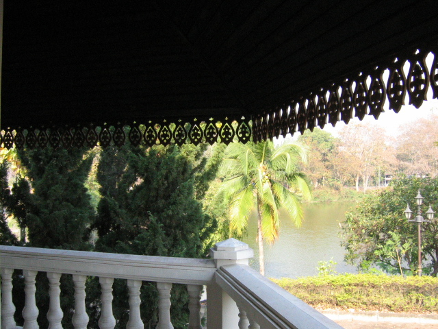 an image of a balcony with trees and water