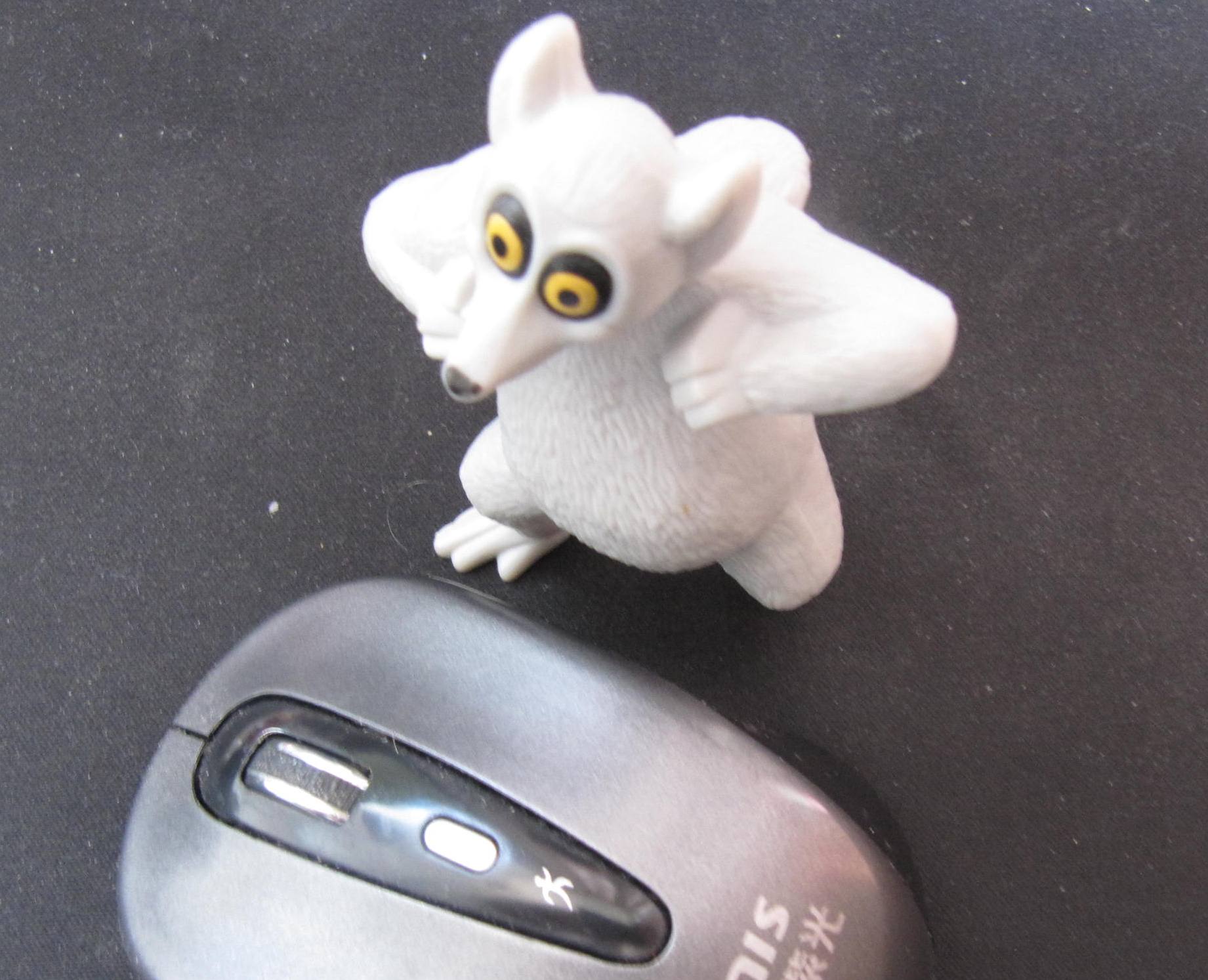 a close up of a toy mouse with a rat figurine