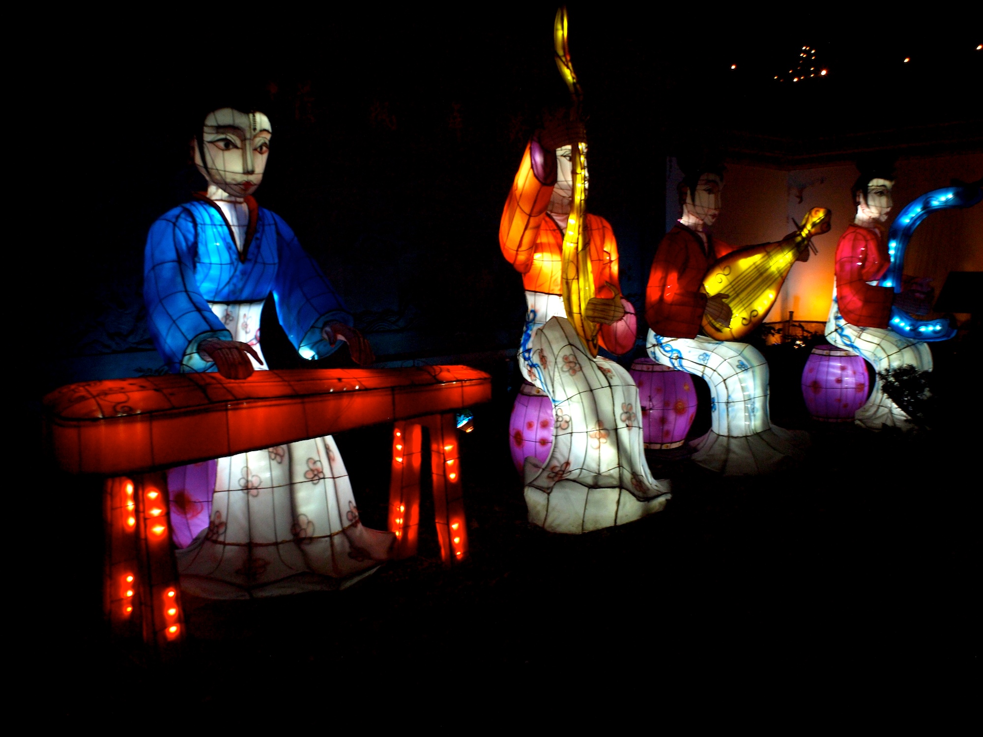 several large lighted lanterns are being displayed at night