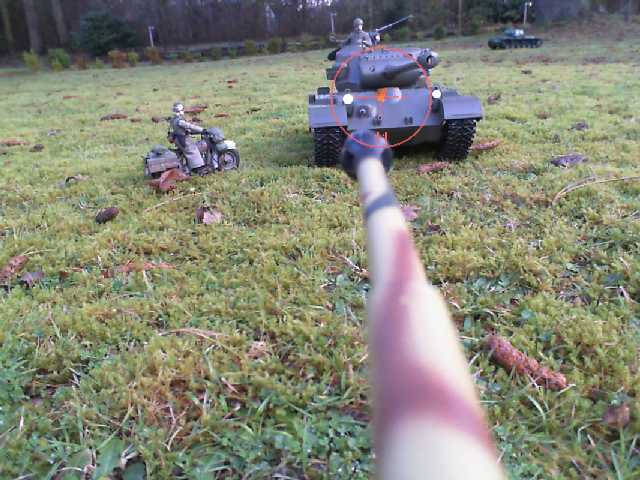 an armored toy tank on a lawn with toys
