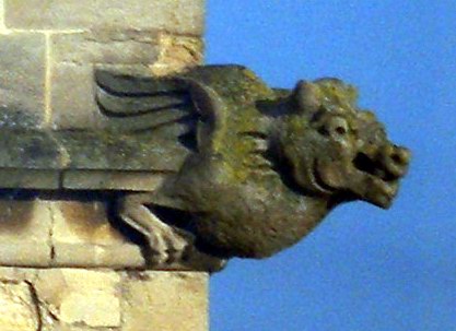 a stone statue of a gargoyle head with outstretched wings