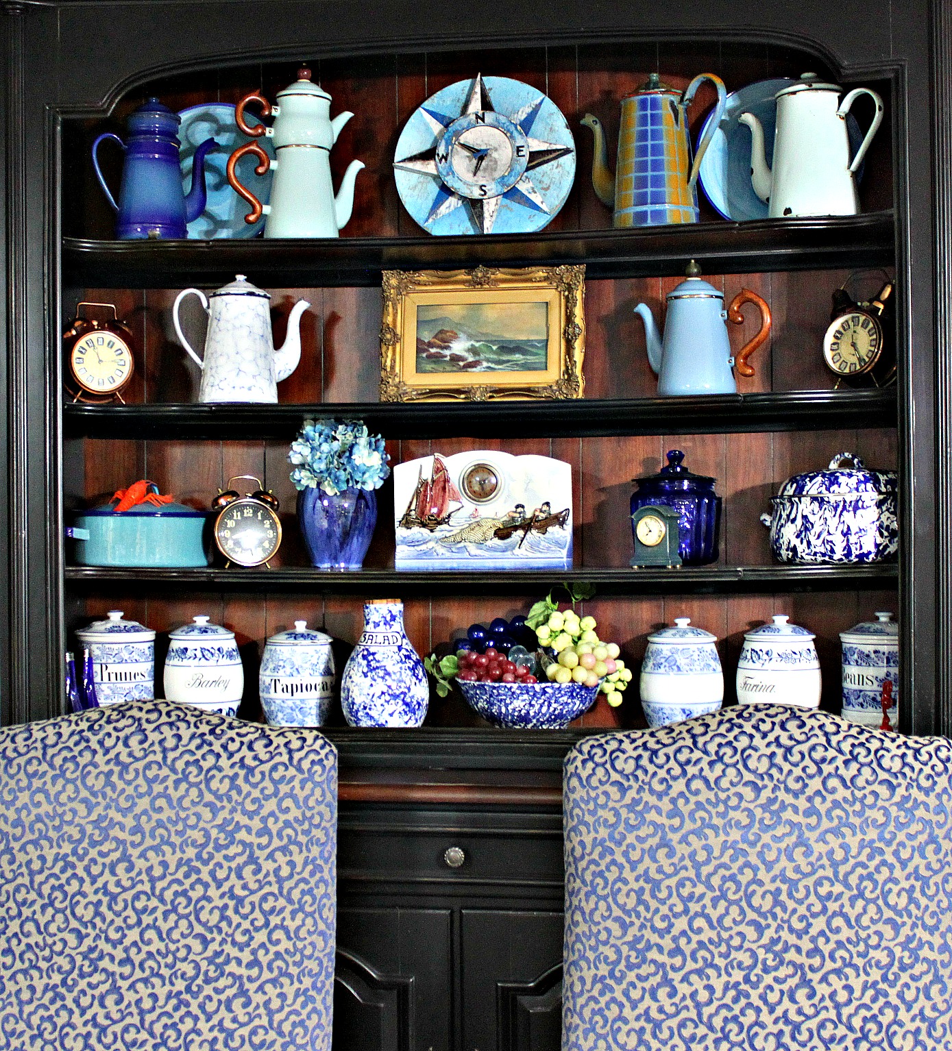 the bookshelf has a shelf of vases and dishes in it