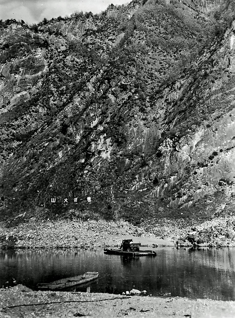 a small boat sits next to some mountains