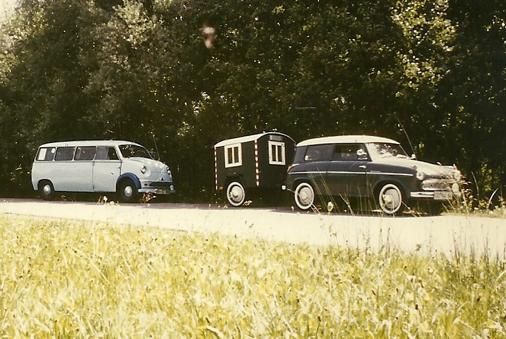 three old fashioned cars parked beside each other