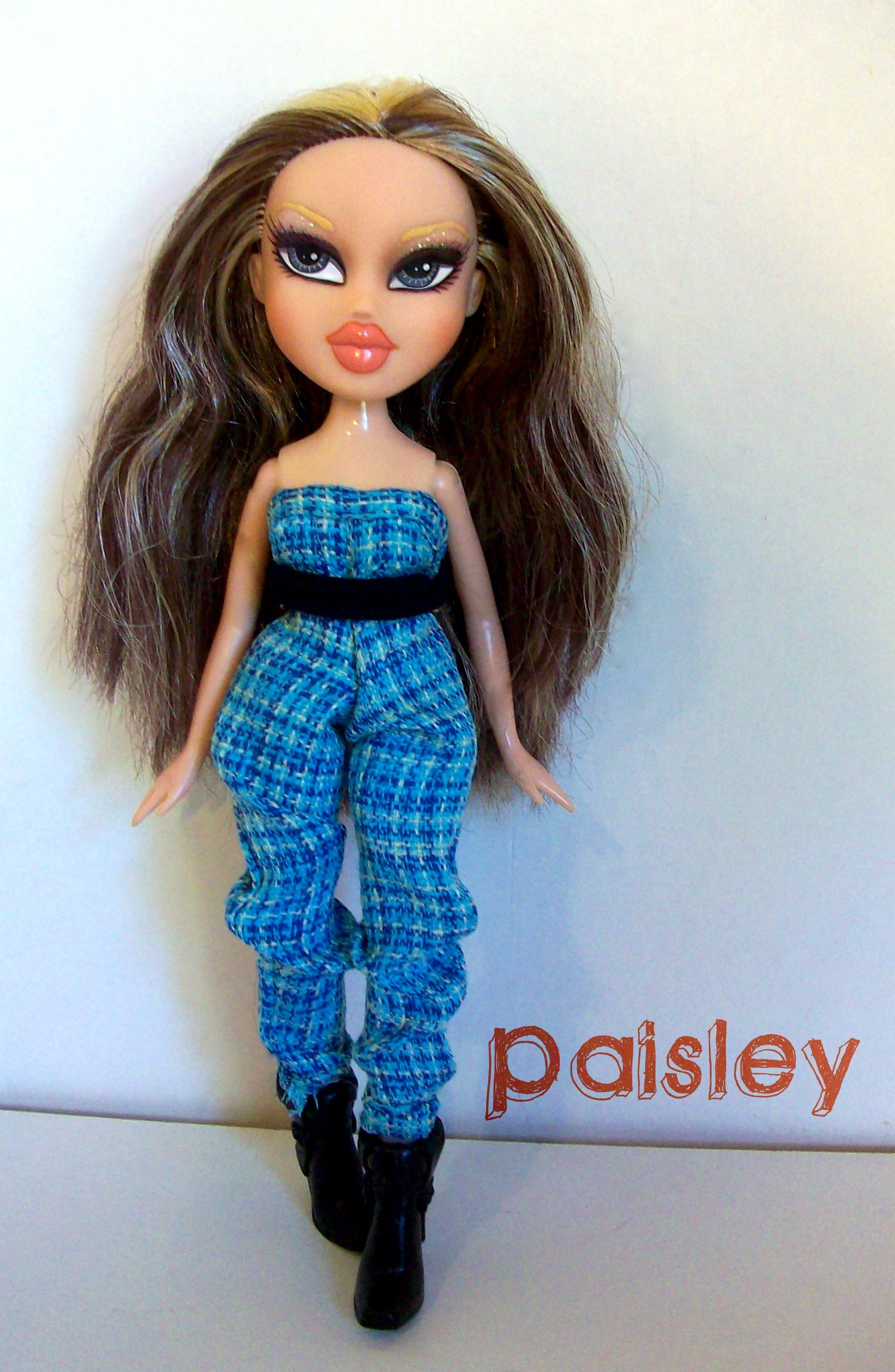 the doll is wearing blue pants with an open top