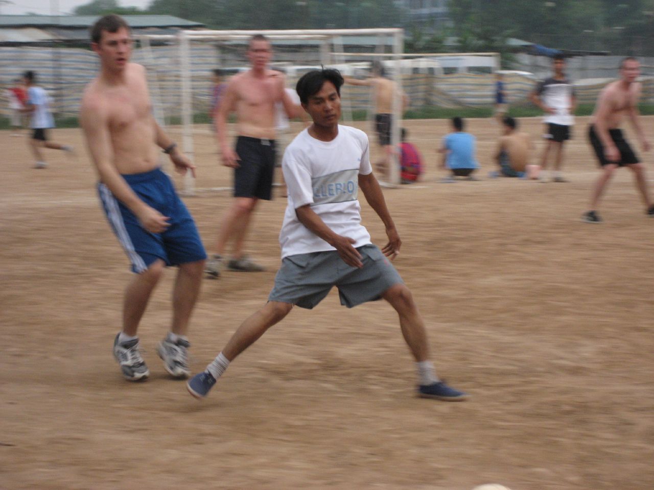 four people are playing soccer on the field