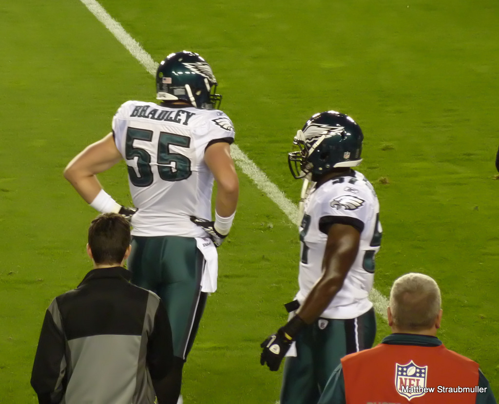 two eagles players congratulate each other on the field