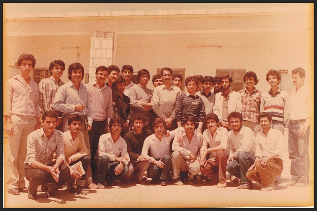 a group of men standing around each other