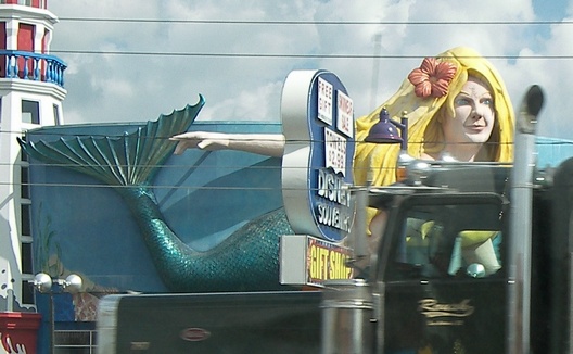 a statue is standing on the back of a pickup truck