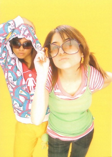 two young women wearing sun glasses standing next to each other