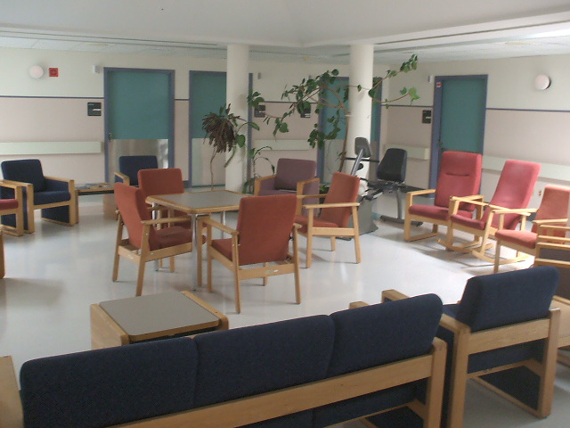 several seats and tables in a room with doors and windows