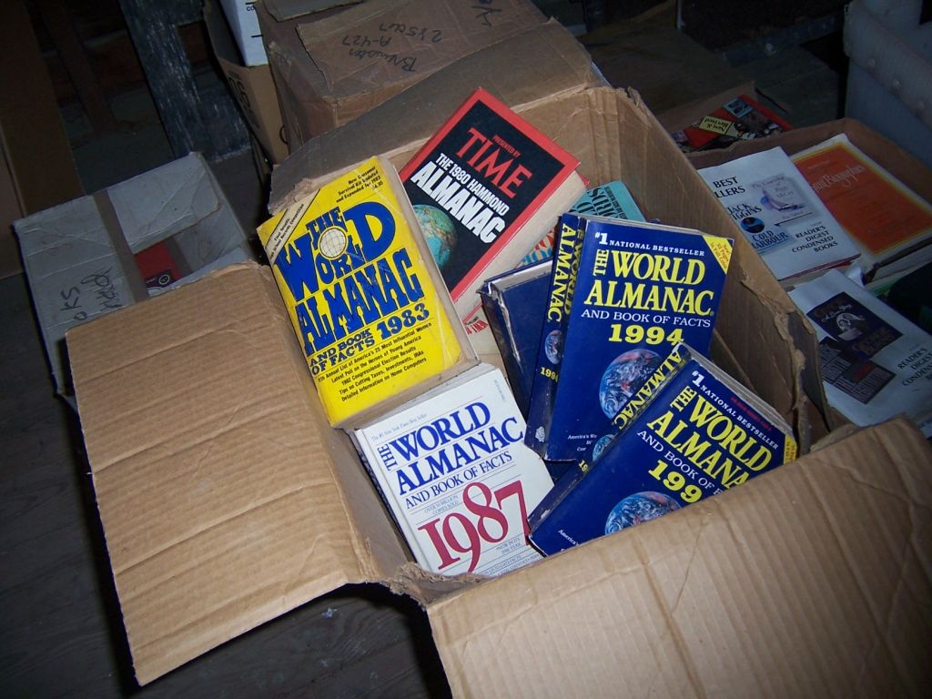 a cardboard box filled with assorted pamphlets