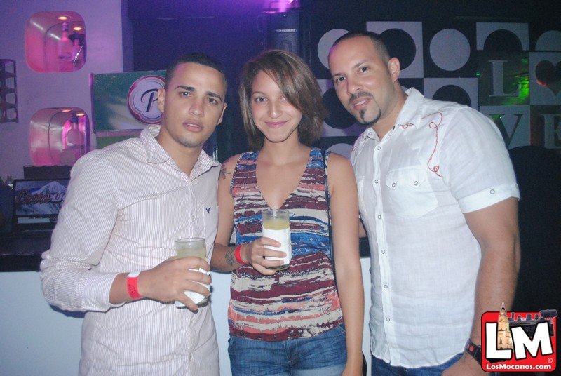 three people posing for a po at a club