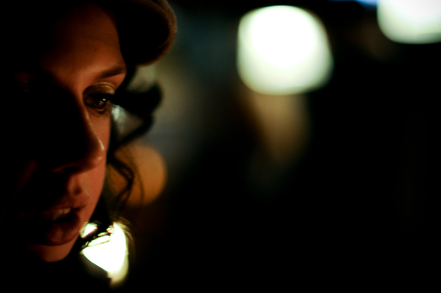 woman staring into the camera with light shining on her face