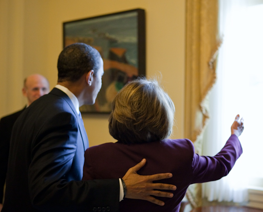 obama hugging an elderly woman in the middle of a room