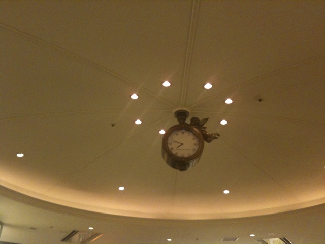 a clock with a light in the ceiling