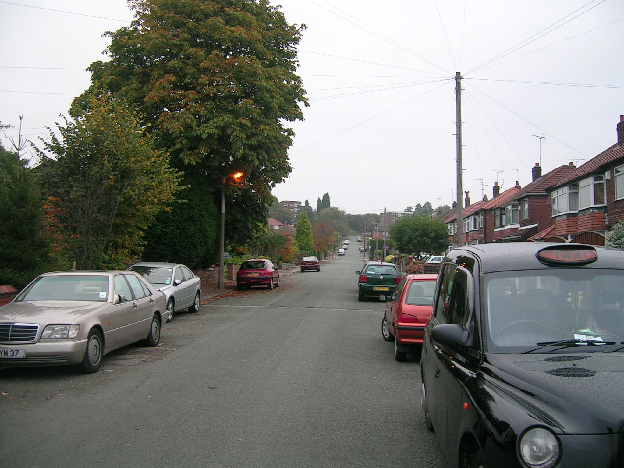 a street lined with cars parked along side each other