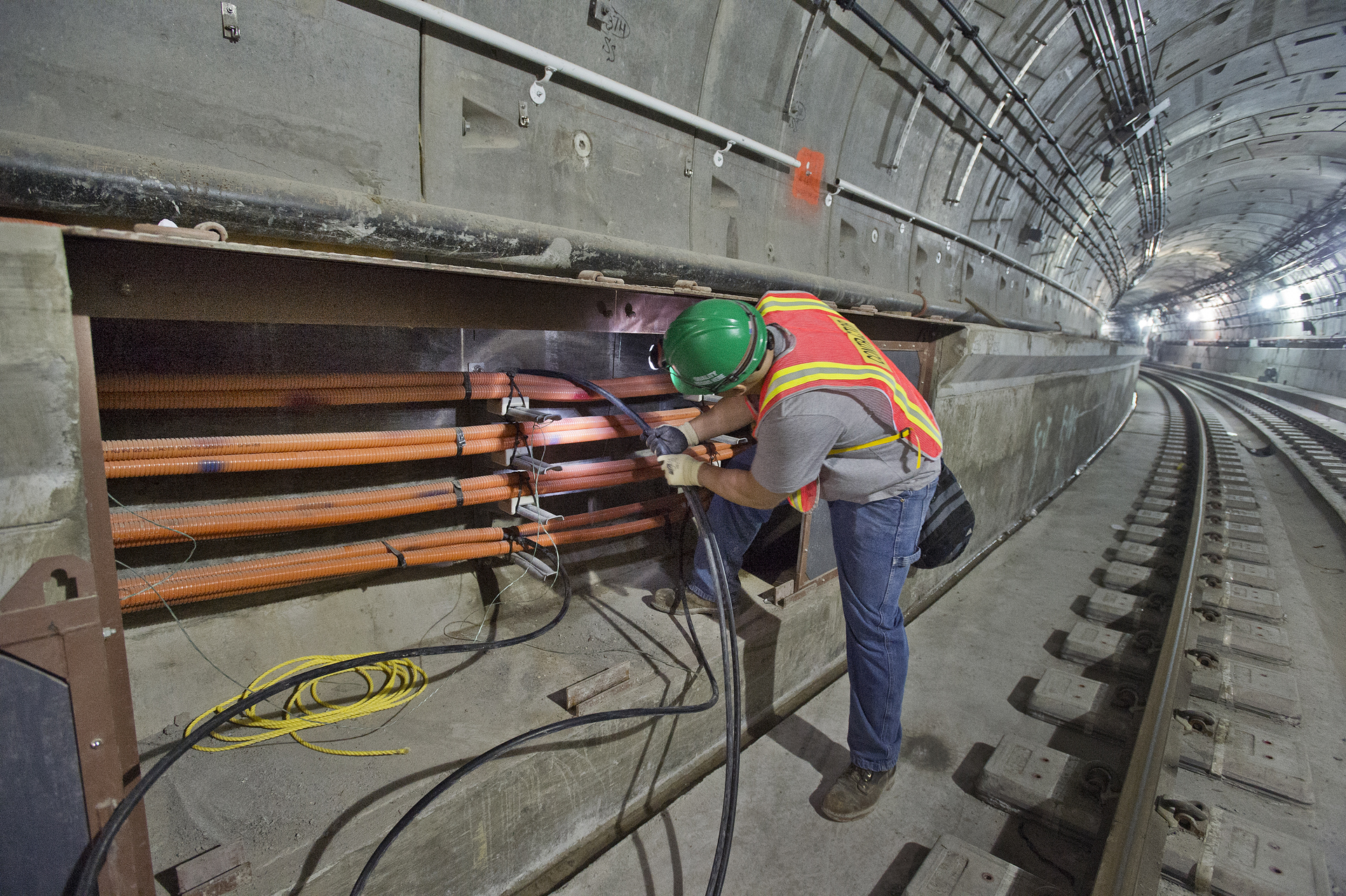 an electric worker working on the rail way in a large building