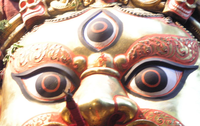 an elaborate gold face on display in a store