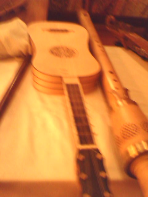 several guitar sitting on a table with a napkin