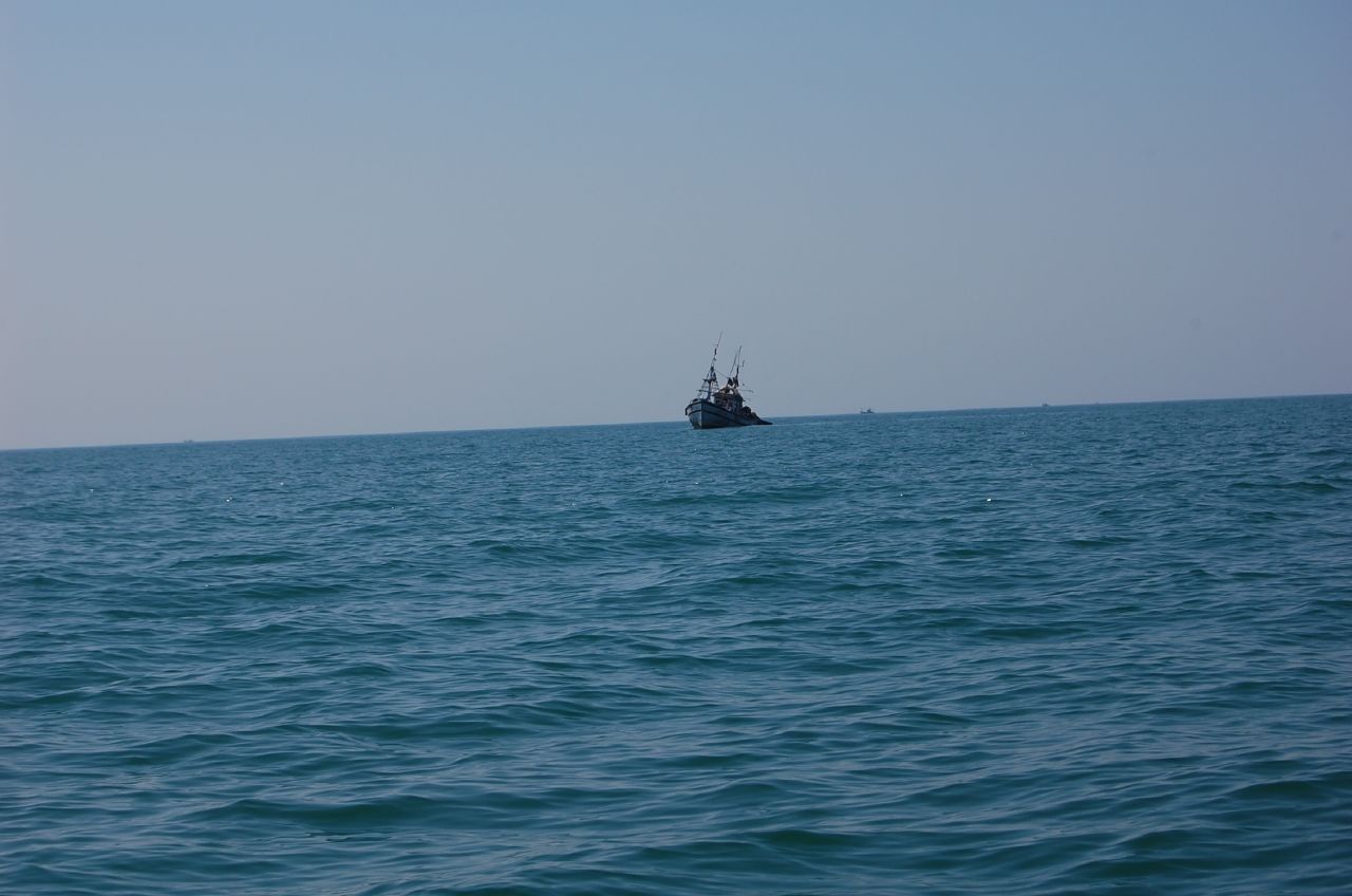 a boat that is floating in some blue water