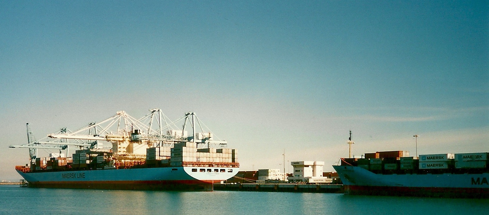 an ocean - side view of two large boats moored