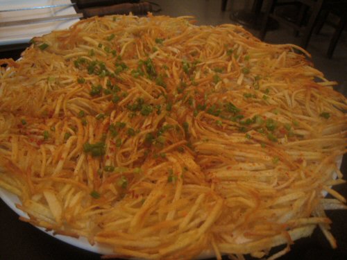 a very large fritter dish sitting on a table