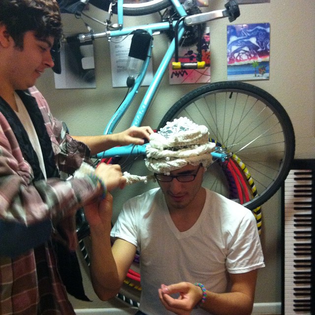 two boys in a room with a bike