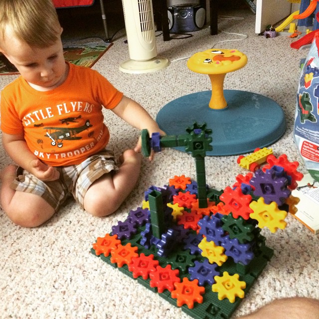 a toddler playing with a colorful puzzle