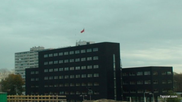a black building with red and green accents in the city