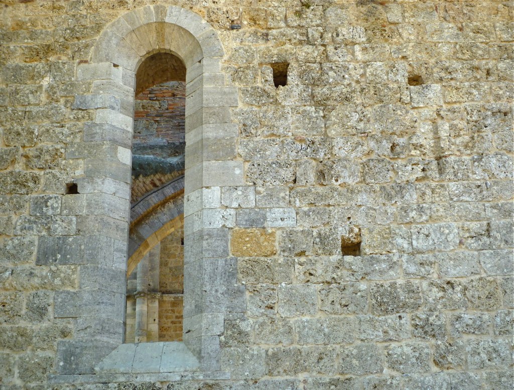 there is a stone building with a window in it