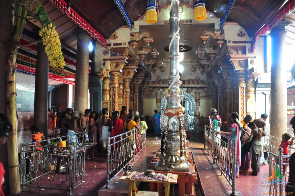 people praying inside an ornate and colorfully decorated temple