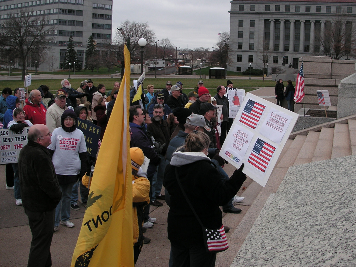 a group of people standing around holding flags