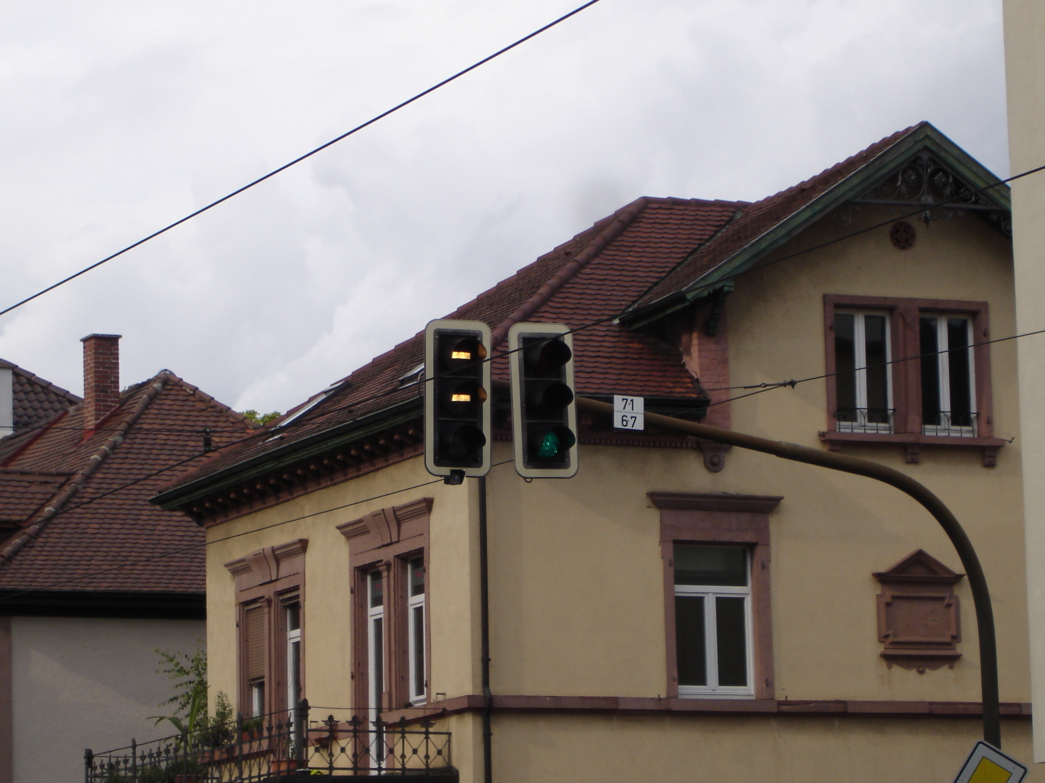 a street light attached to a building in a village