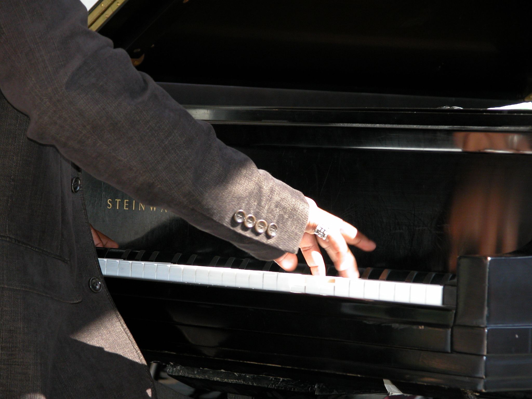 a man reaching into the piano to learn soing