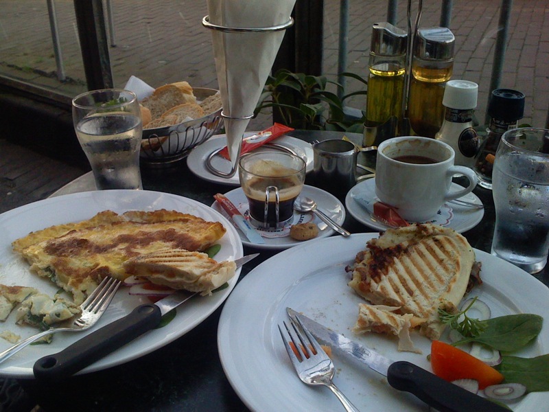 two plates filled with food and some cups on top of them