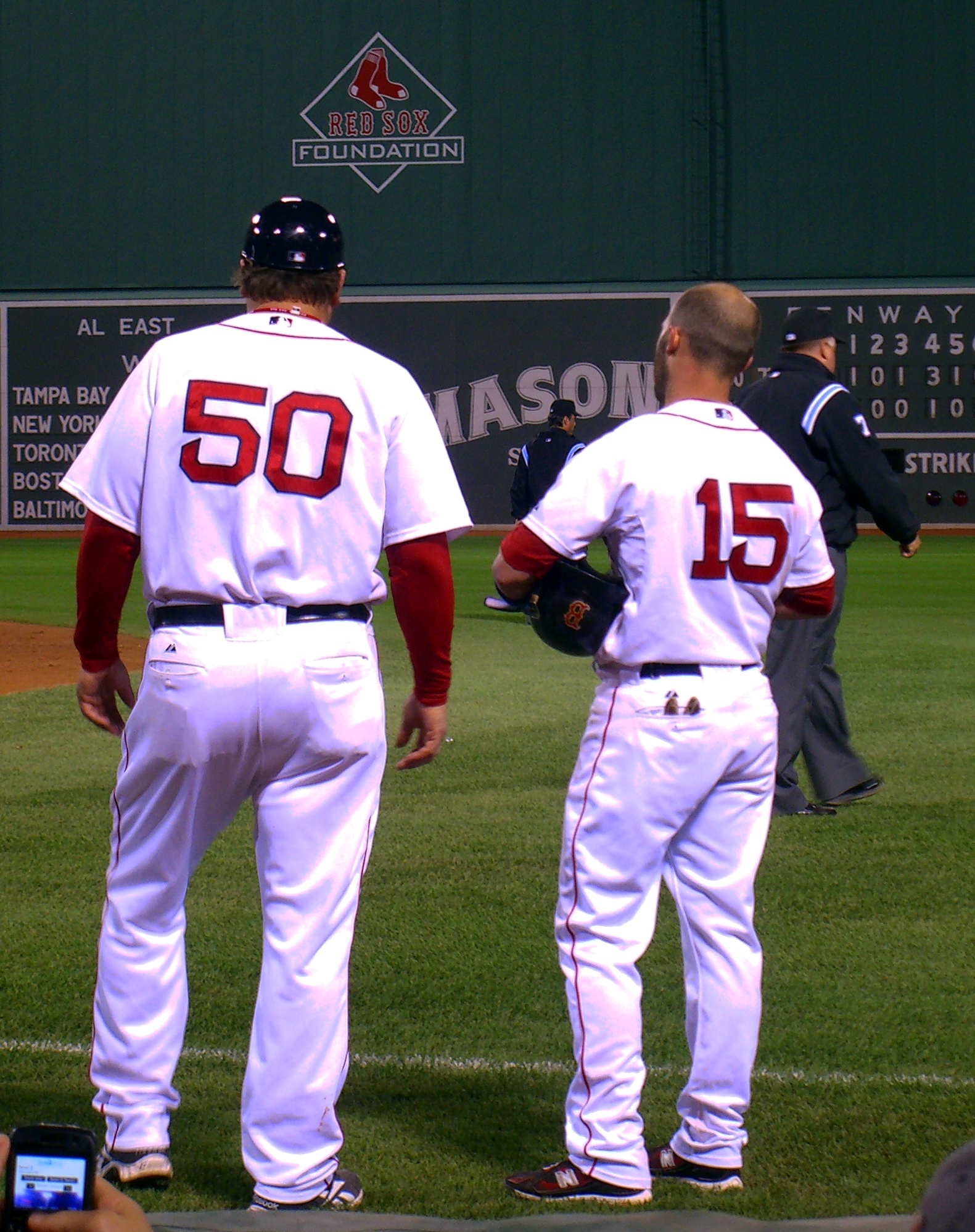 two baseball players stand together at the field