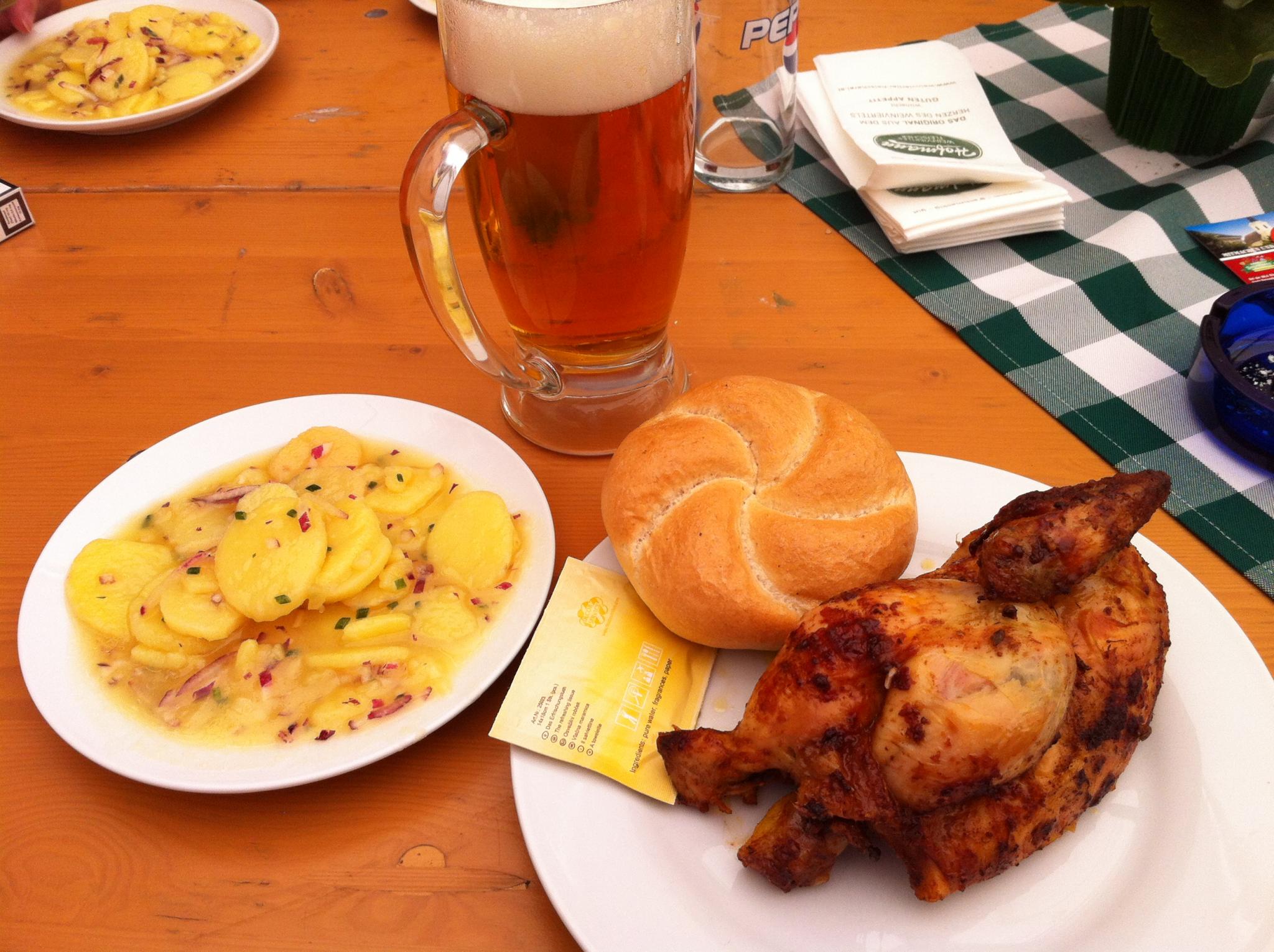 some food is on plates and next to a mug of beer